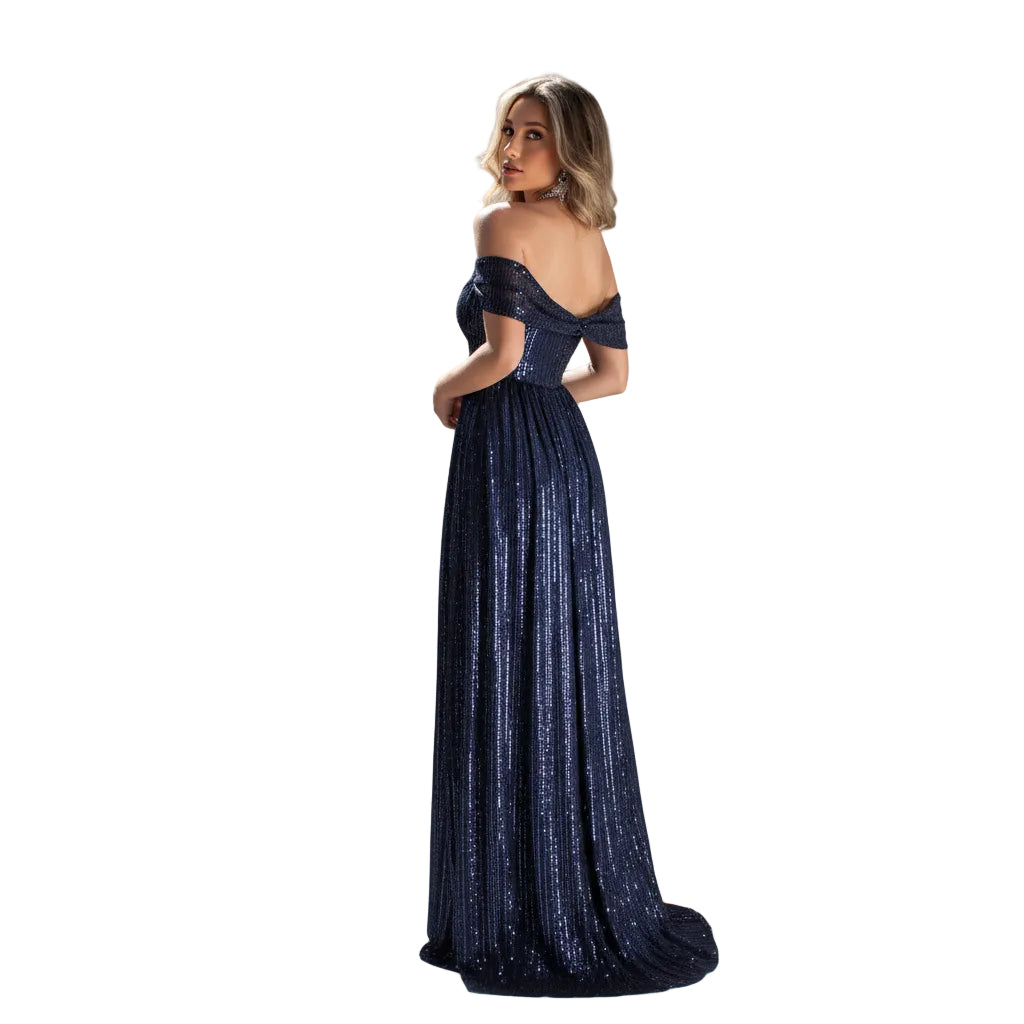 Woman in a blue evening gown standing in front of an ornate building with domes.