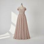 Elegant off-shoulder gown with a high slit on a gray background