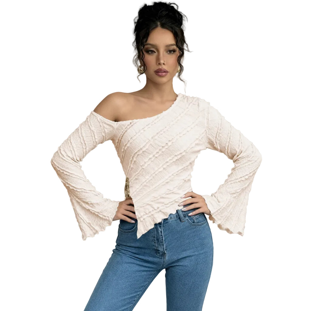 Woman wearing a white off-shoulder top and blue jeans against a gray background