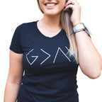 Person wearing a black t-shirt with mathematical symbols outdoors