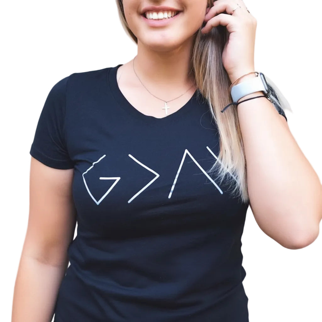 Person wearing a black t-shirt with mathematical symbols outdoors
