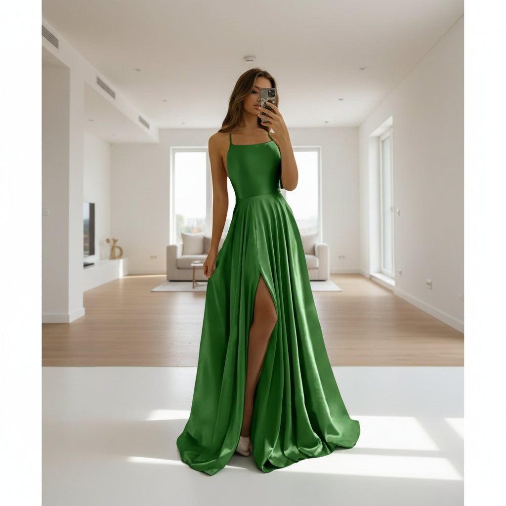 Green evening gown with a slit on a white background
