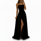 Person wearing a black dress with a high slit in a store setting