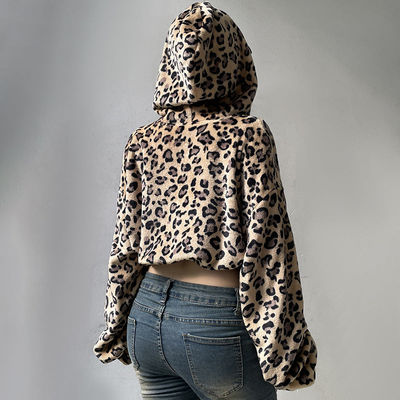 Leopard print hoodie worn by a person on a gray background
