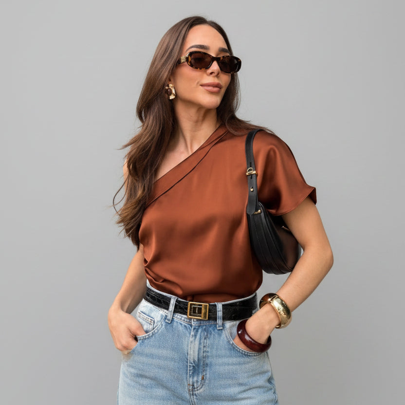 Woman wearing a brown top and sunglasses outdoors
