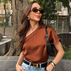 Woman wearing a brown top and sunglasses outdoors