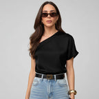 Woman wearing a black top and sunglasses outdoors