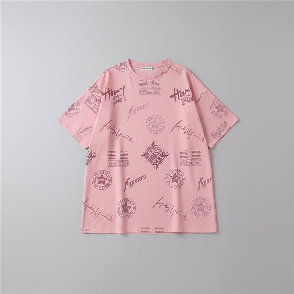 Person wearing a pink oversized t-shirt with text and graphic designs in a casual setting.
