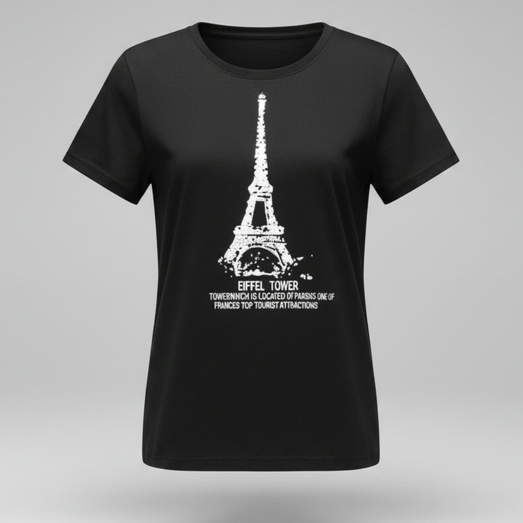 Person wearing a black t-shirt with Eiffel Tower design, sitting on the floor.