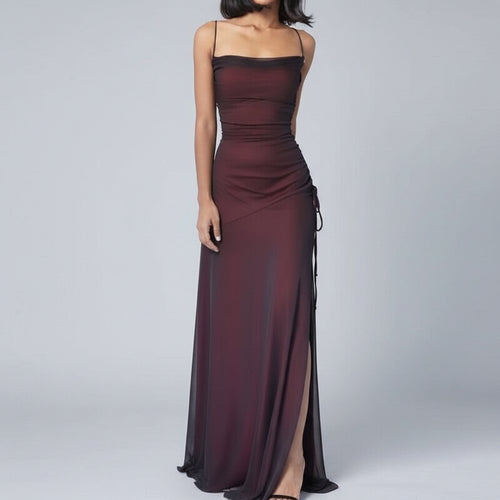 Burgundy evening gown with a slit on a white background