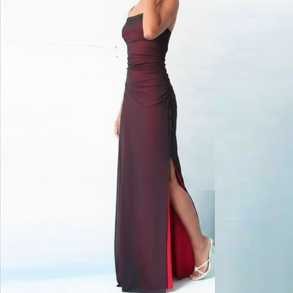 Burgundy strapless gown with a high slit on a light blue background