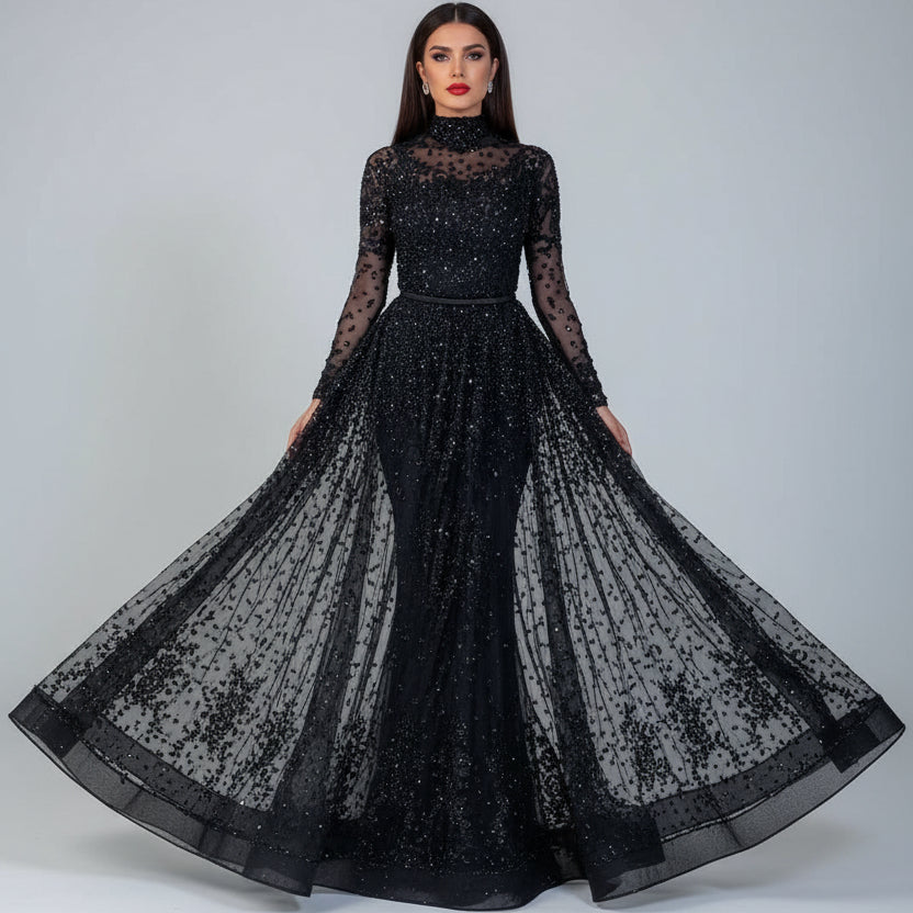 Black sheer evening gown with long sleeves and a flowing skirt on a neutral background
