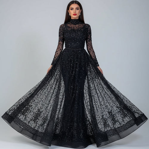 Black sheer evening gown with long sleeves and a flowing skirt on a neutral background