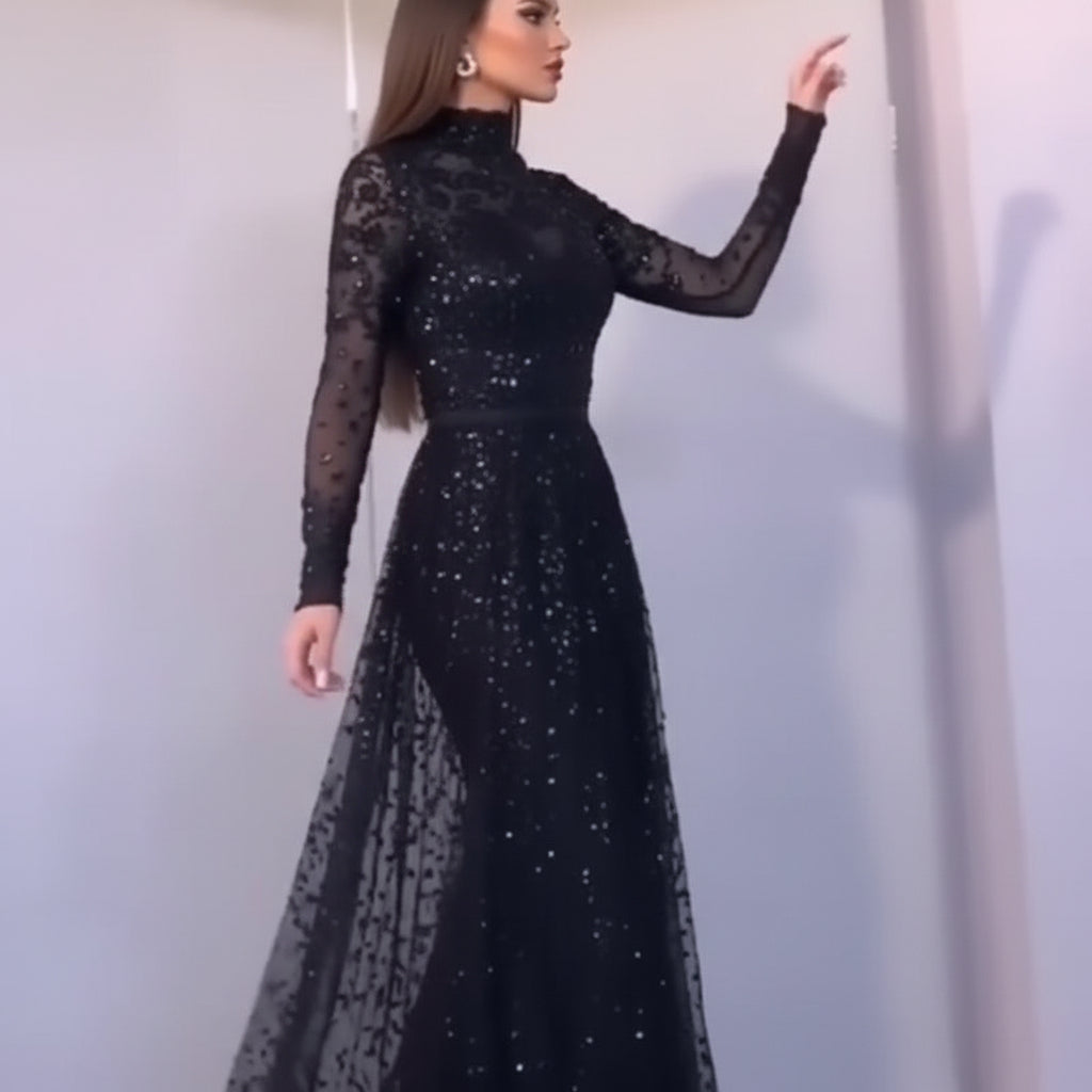 Person wearing a black sequin dress against a neutral background