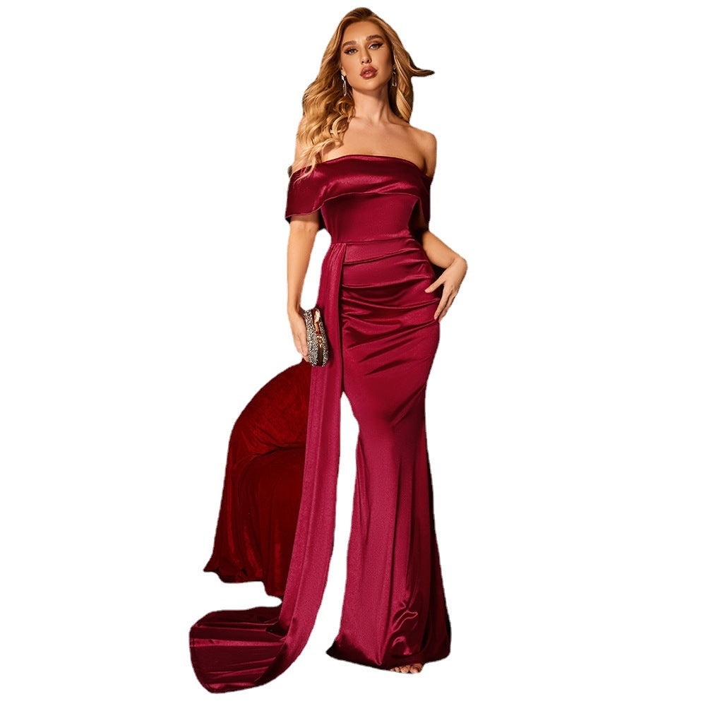 Woman wearing a burgundy off-shoulder gown on a white background