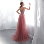 Pink evening gown with beaded back in a softly lit room