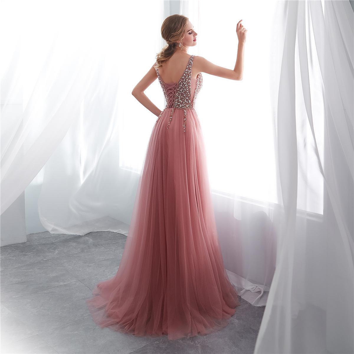 Pink evening gown with beaded back in a softly lit room